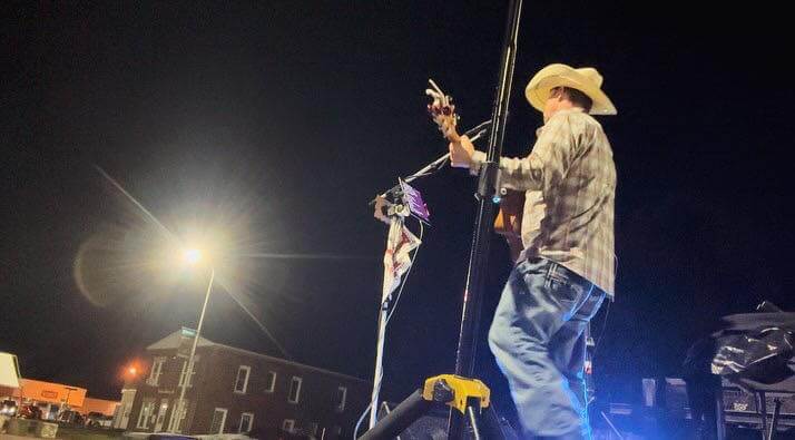 Acoustic guitarist performing live music at Rolling Forks VIneyards patio in Glenwood, MN during a weekend wine tasting event.
