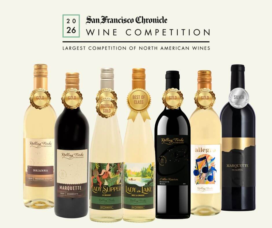 A lineup of award-winning Rolling Forks Vineyards wine bottles, including Lady of the Lake and Marquette, displayed with their San Francisco Chronicle Wine Competition gold and silver medals.