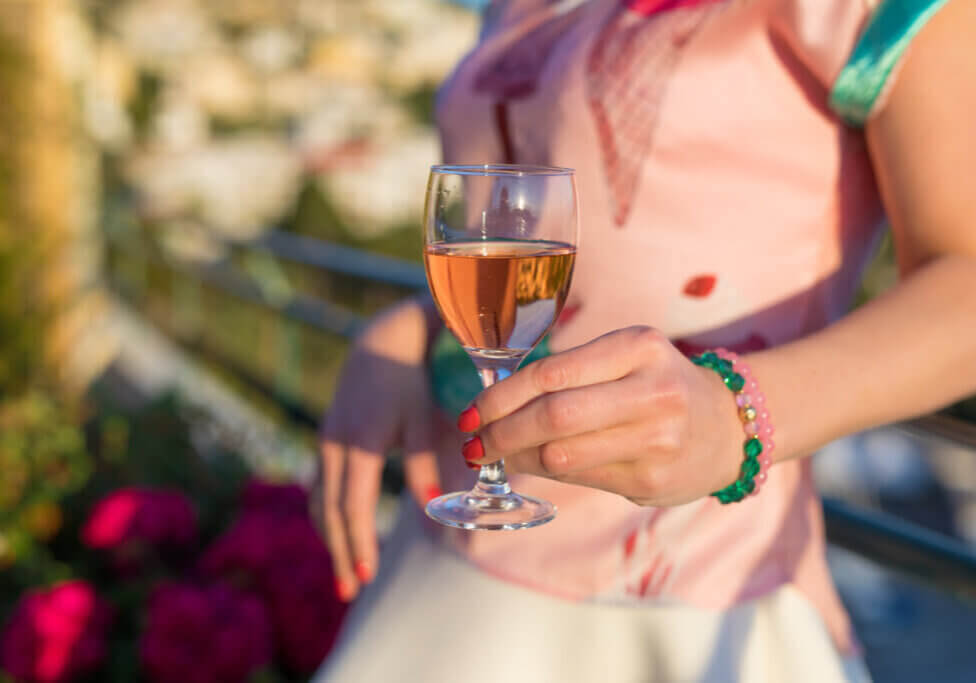 Woman holding glass of rose wine